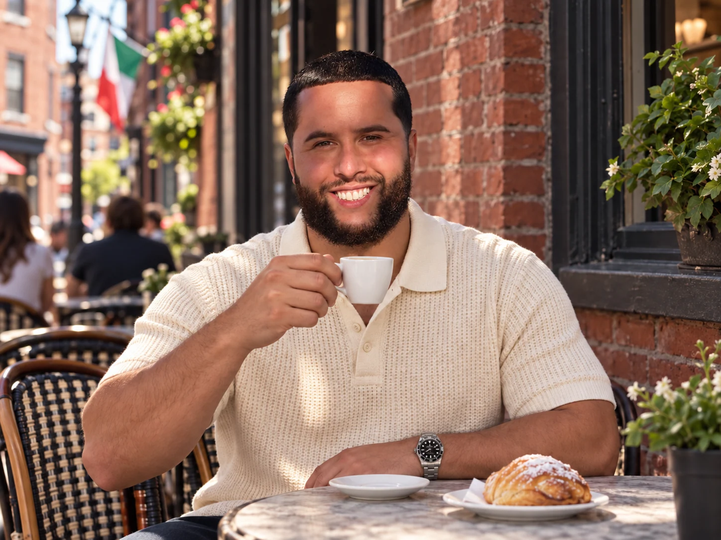 C-Money sitting with a coffee outdoors.